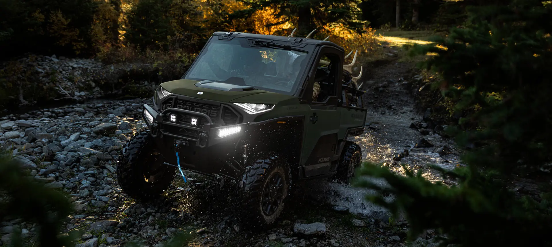 Polaris RANGER XD 1500 NorthStar Edition extreme duty UTV climbing over wet rocky terrain with ease.