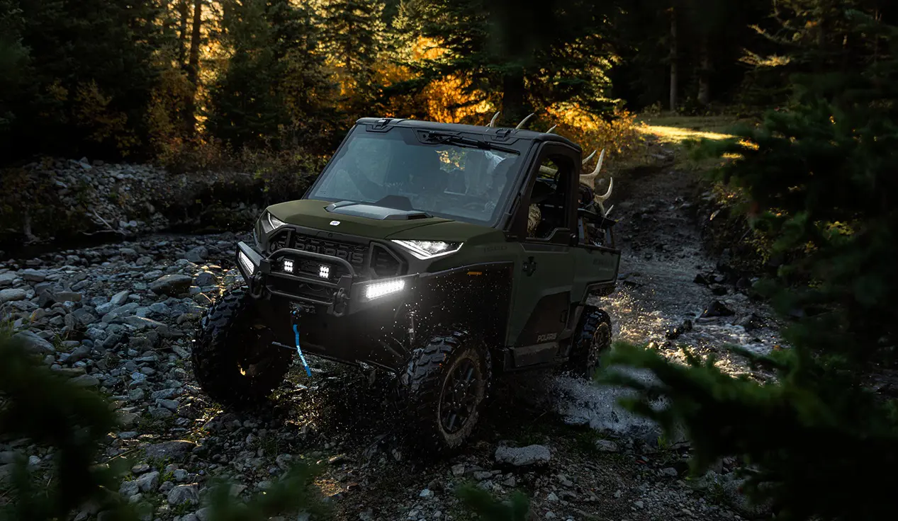 Polaris RANGER XD 1500 NorthStar Edition extreme duty UTV climbing over wet rocky terrain with ease.