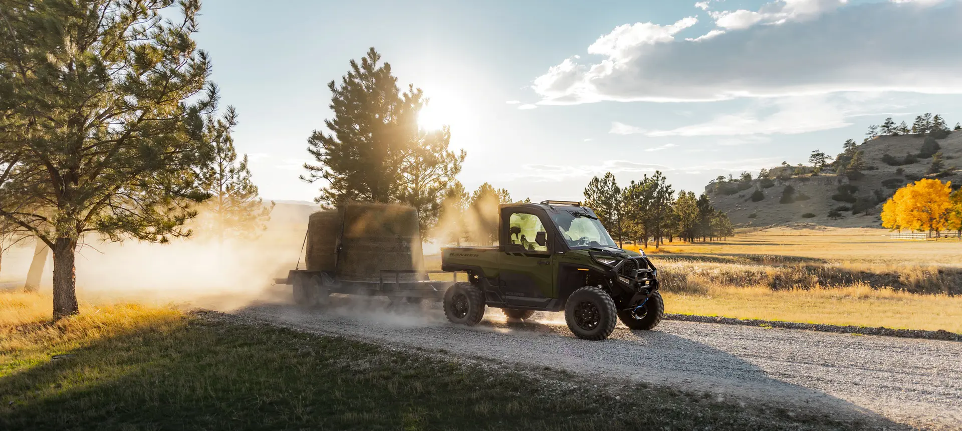 A Polaris RANGER XD 1500 NorthStar Edition extreme duty UTV pulling a fully loaded trailer with ease.