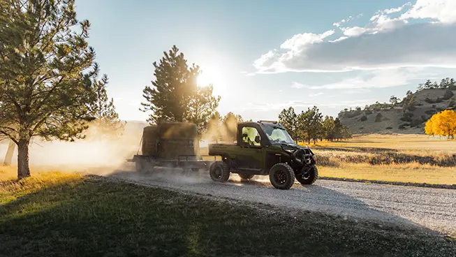A Polaris RANGER XD 1500 NorthStar Edition extreme duty UTV pulling a fully loaded trailer with ease.