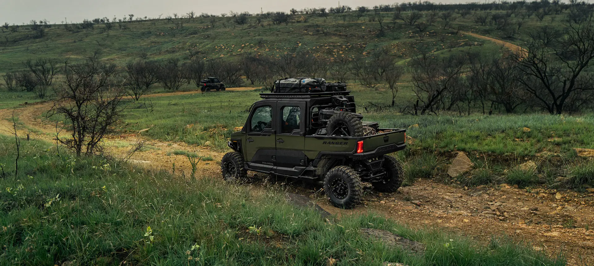 Side view of a Polaris RANGER CREW XD 1500 NorthStar Edition extreme duty UTV cruising on a trail.