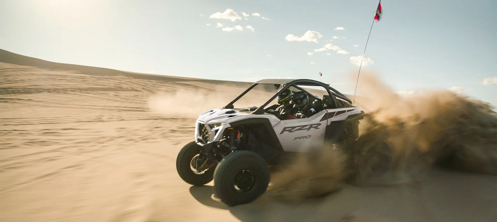 A Polaris RZR Pro R side-by-side driving through the desert.