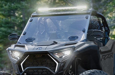 A Polaris RZR Pro XP side-by-side with a windshield installed.