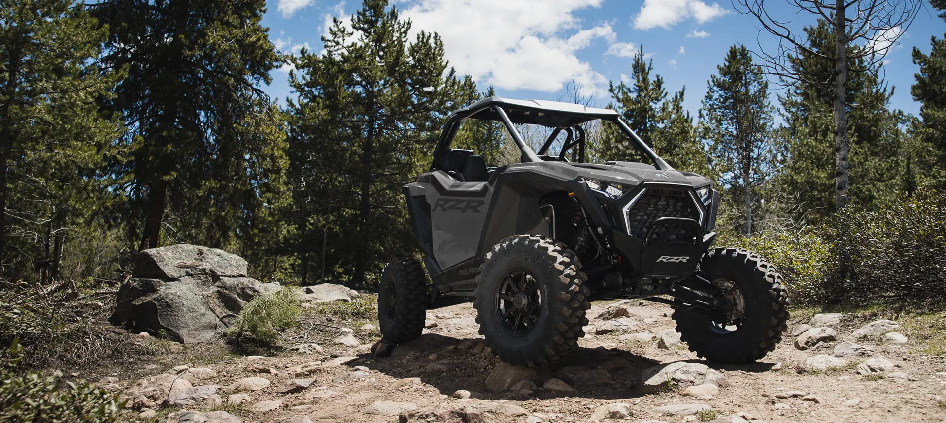 A Polaris RZR Pro XP side-by-side parked on a rocky hill.