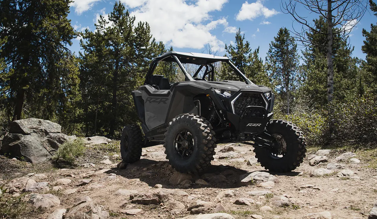 A Polaris RZR Pro XP side-by-side parked on a rocky hill.