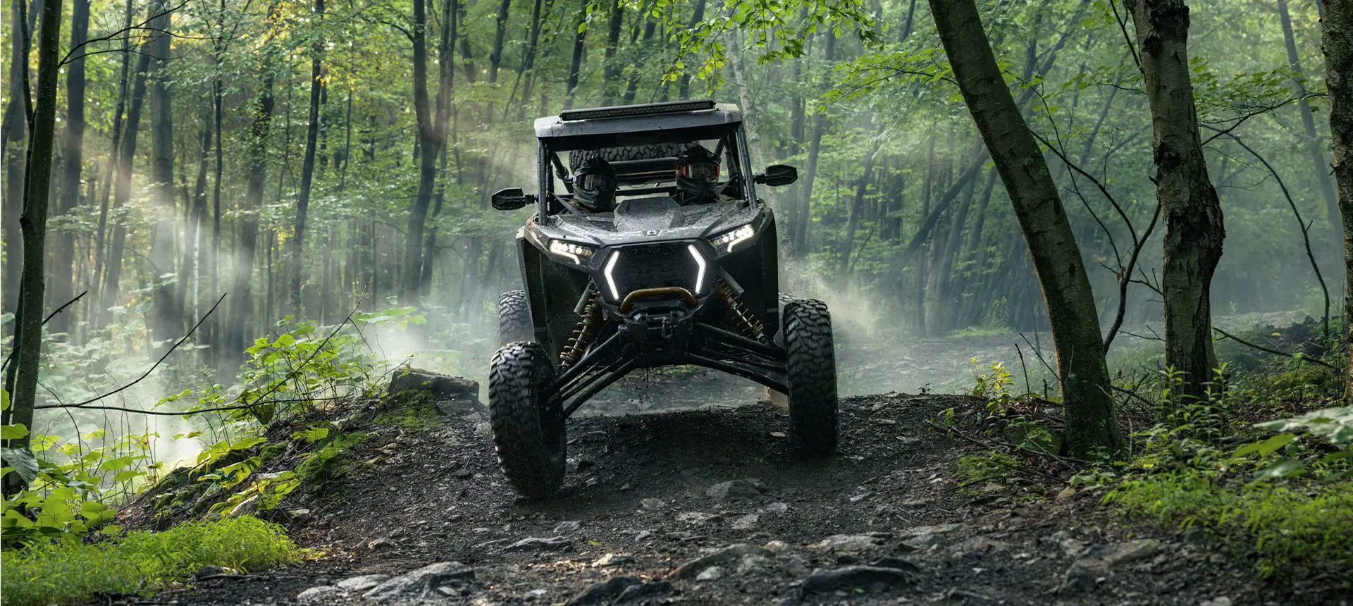 Polaris RZR XP side-by-side descending a hill.