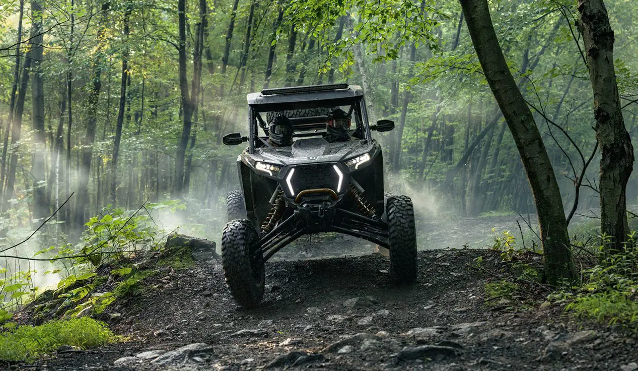 Polaris RZR XP side-by-side descending a hill.