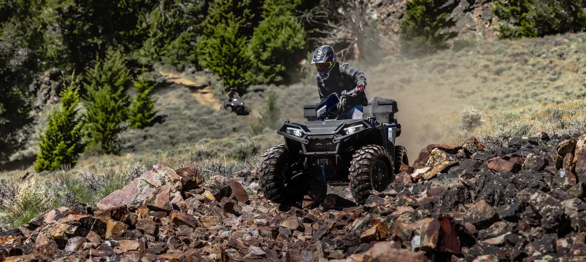 Polaris Sportsman 850 ATV crawling over rocky terrain.