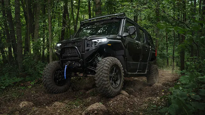 A Matte Super Graphite Polaris XPEDITON ADV 5 performance side-by-side crawling over rocky terrain.