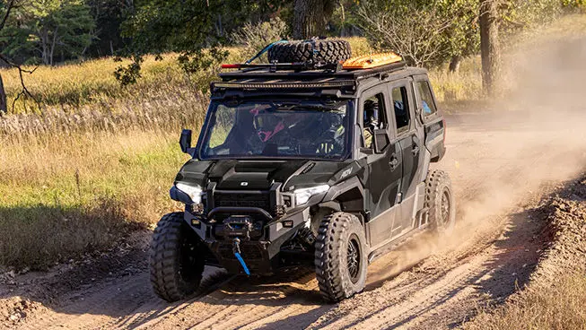 A Matte Super Graphite Polaris XPEDITION ADV 5 NorthStar cruising down a dusty trail.