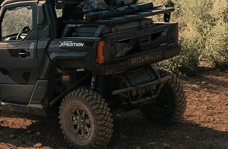 A Polaris XPEDITION performance side-by-side with bumper & guards accessories installed. 