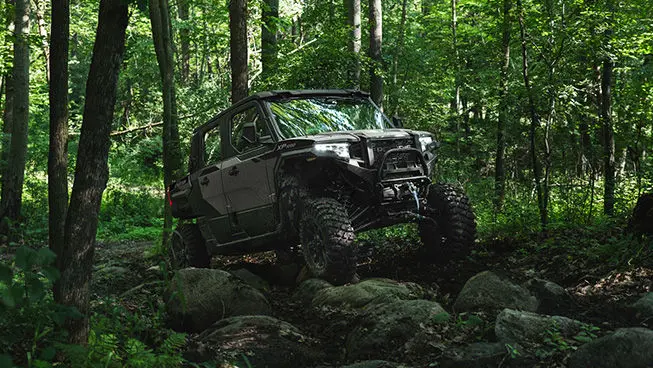 A Slate Gray Polaris XPEDITION XP 5 NorthStar side-by-side crawling over rocky terrain.