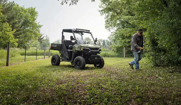 A man pulling out the winch from the front end of his Polaris RANGER 500 UTV.