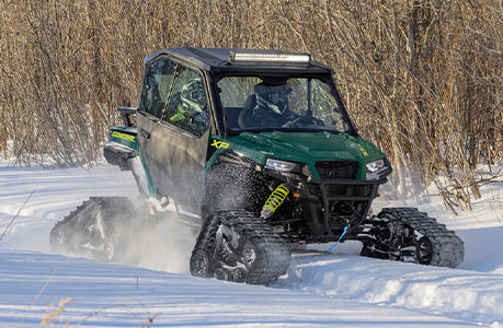 A Polaris GENERAL SxS with tracks and other winter accessories installed. 