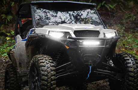 Front end of a Polaris GENERAL SxS with lighting accessories installed.