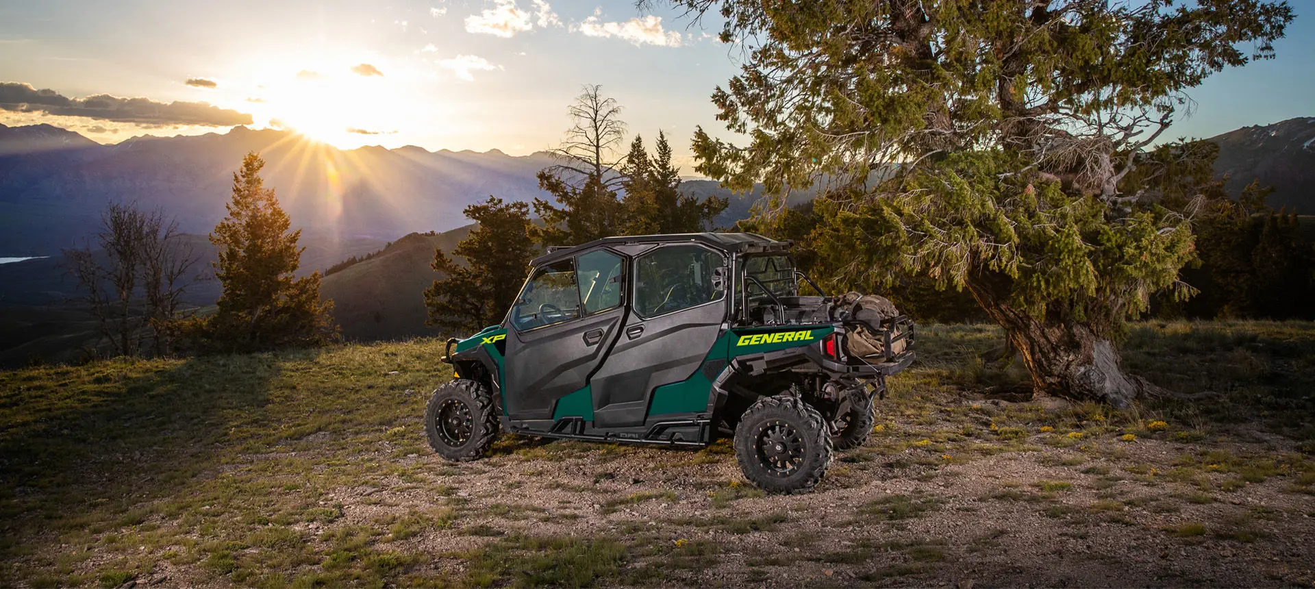Side profileof a Polaris GENERAL XP 1000 side-by-side with full door accessories installed at sunset.