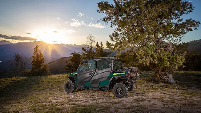 Side profileof a Polaris GENERAL XP 1000 side-by-side with full door accessories installed at sunset.