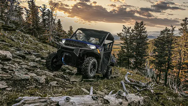 A Polaris RANGER 1000 UTV climbing over rocky terrain.