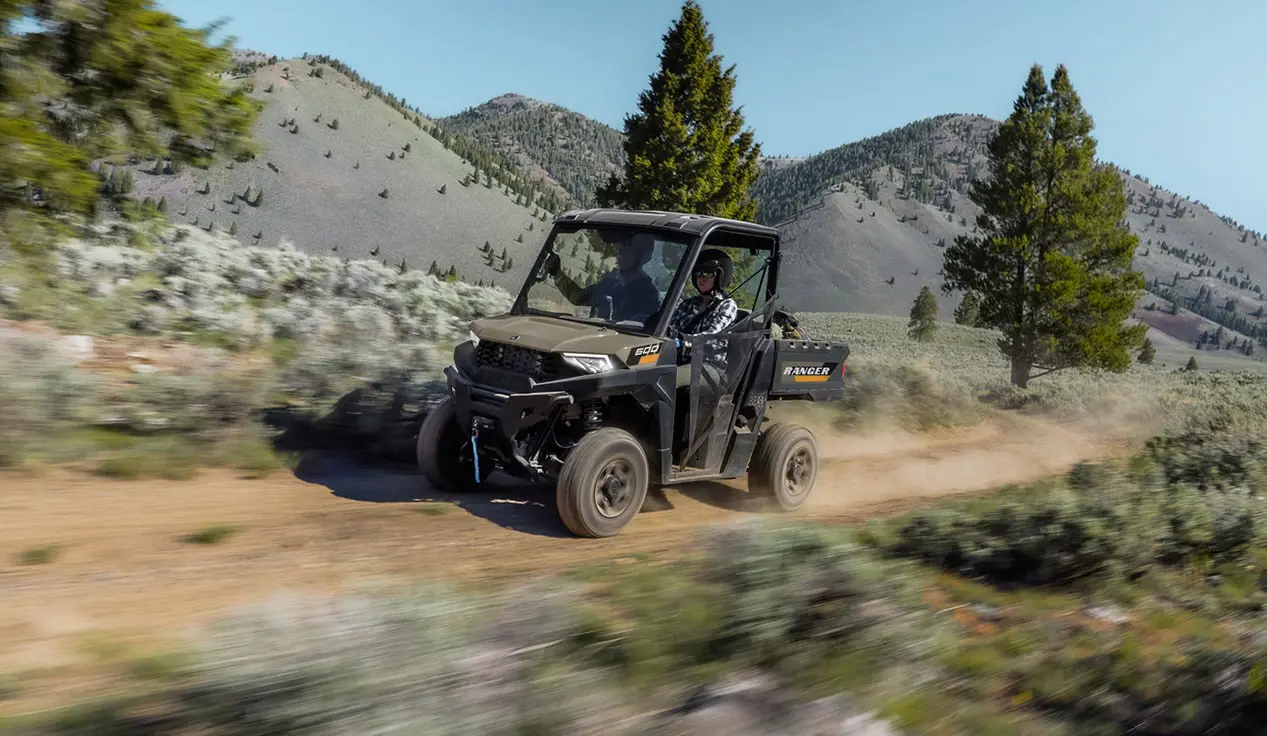 A Polaris RANGER 600 UTV driving on a trail.