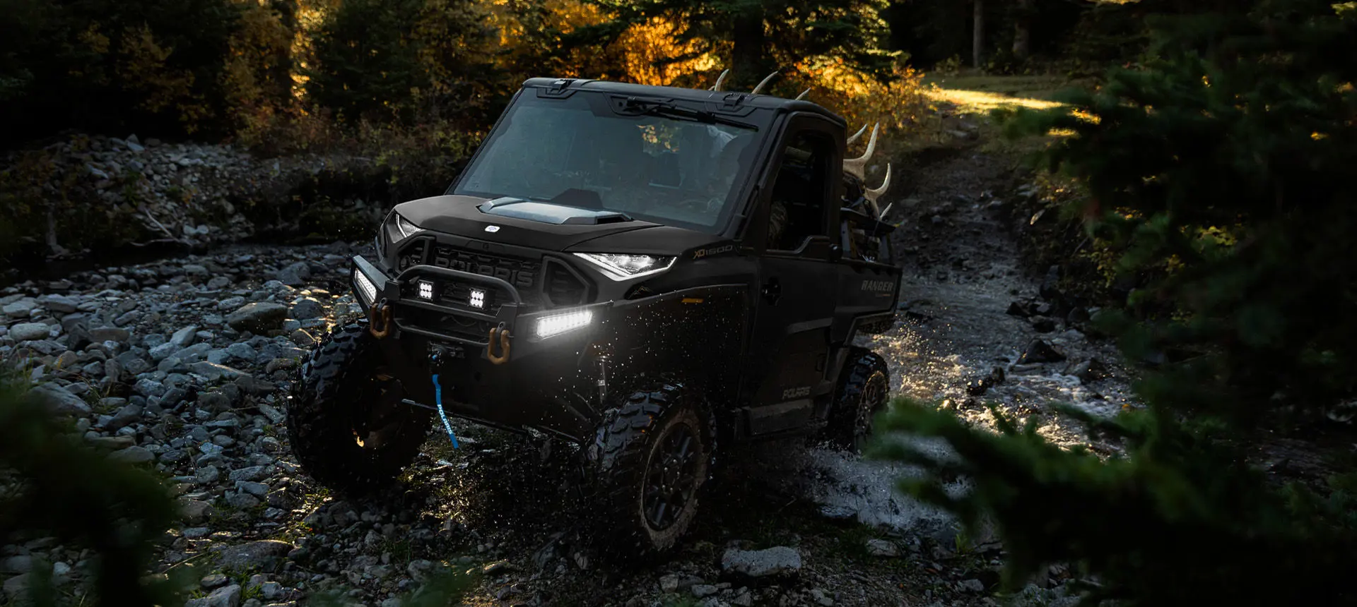 Polaris RANGER XD 1500 NorthStar extreme duty UTV climbing over wet rocky terrain with ease.