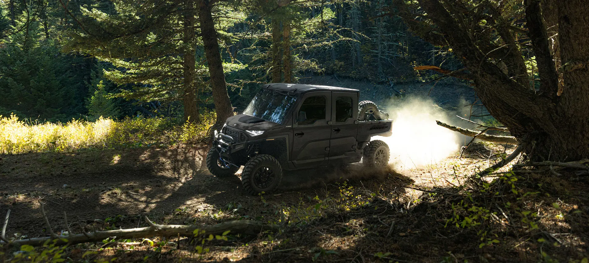 A Polaris RANGER CREW XD 1500 NorthStar extreme duty UTV driving through the forest.