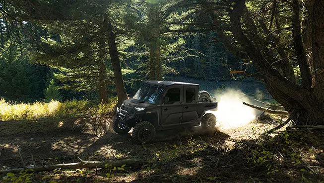 A Polaris RANGER CREW XD 1500 NorthStar extreme duty UTV driving through the forest.