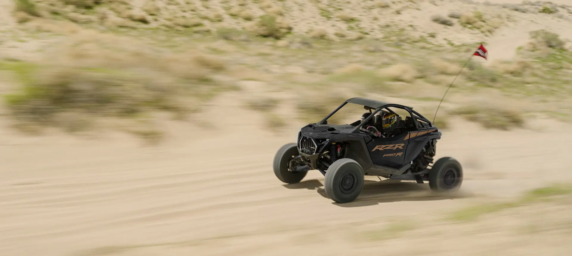 A Polaris RZR Pro R side-by-side cruising through the desert.