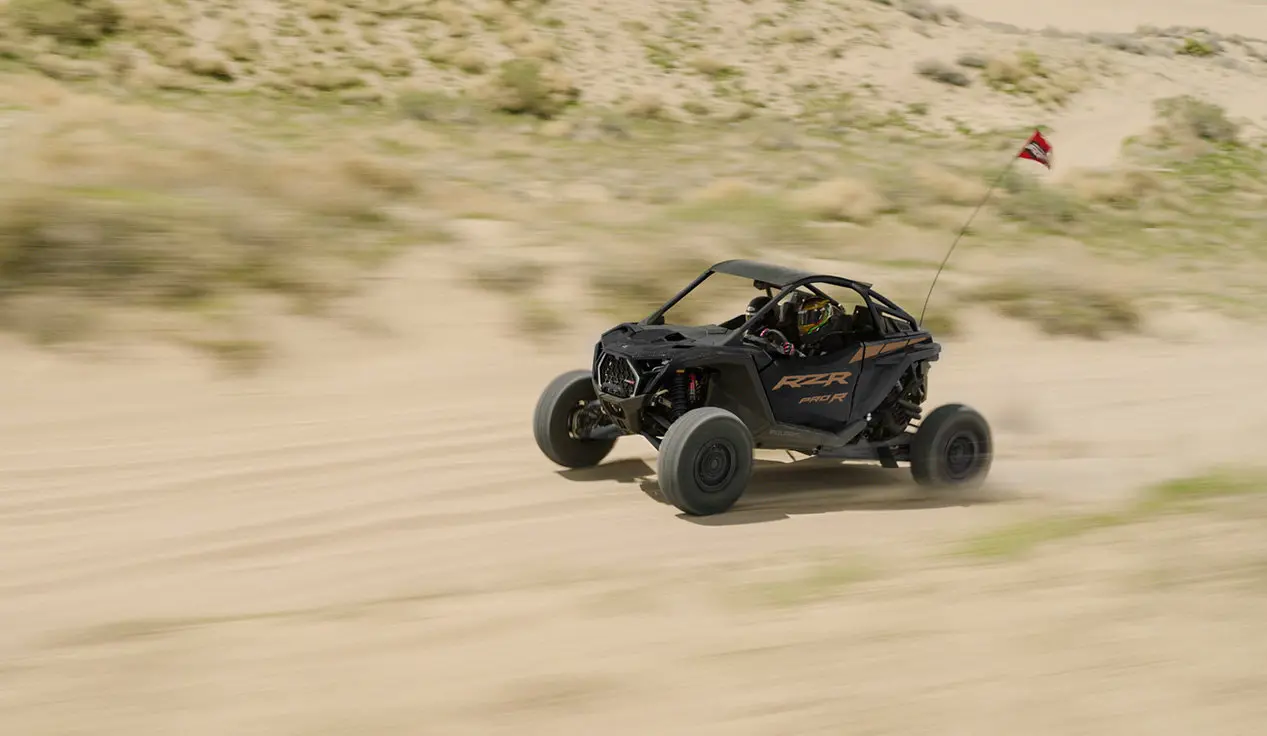 A Polaris RZR Pro R side-by-side cruising through the desert.