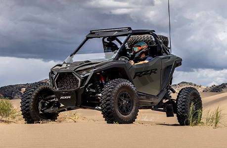 A Polaris RZR Pro S with windshield accessory installed. 