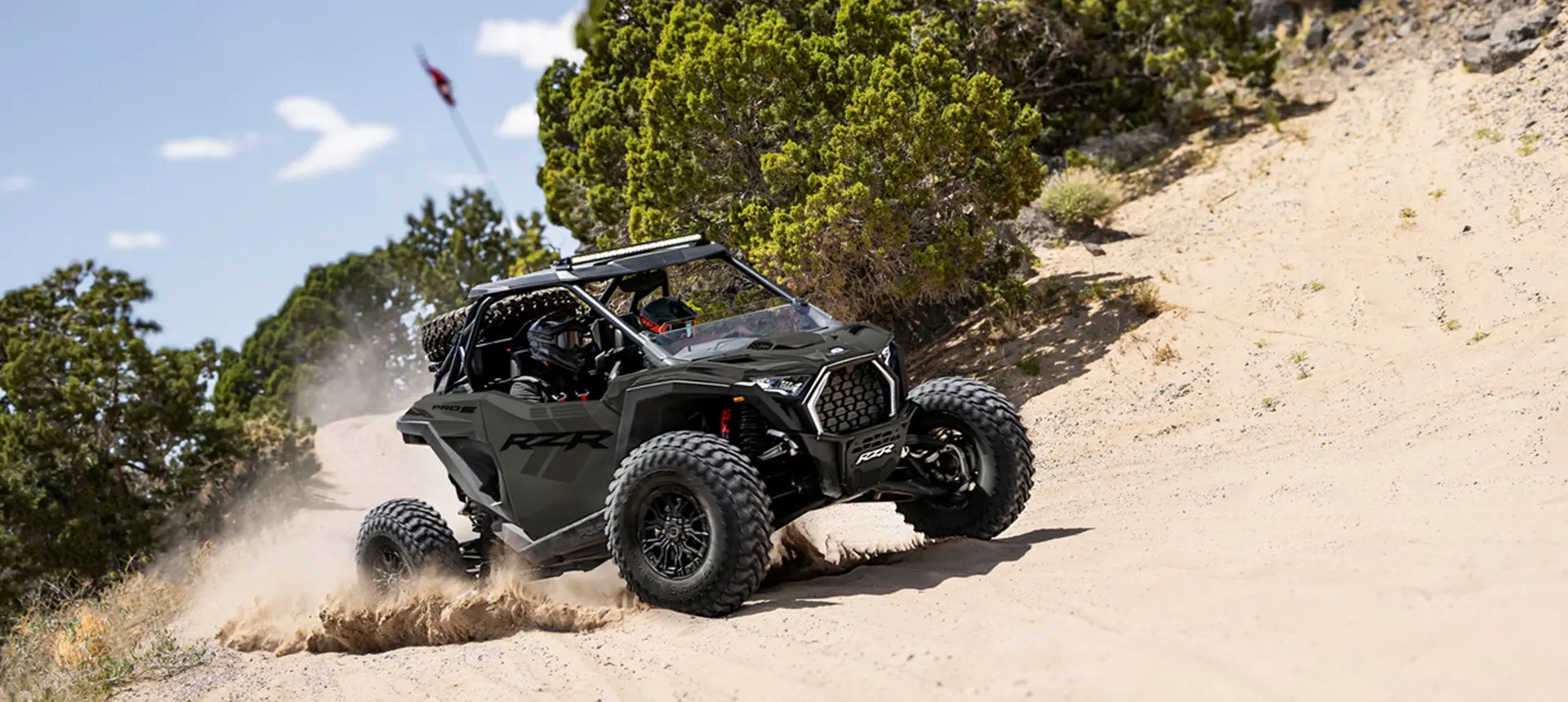 Polaris RZR Pro S side-by-side throwing sand on a corner.