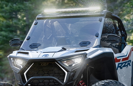 A Polaris RZR Pro XP side-by-side with a windshield installed.
