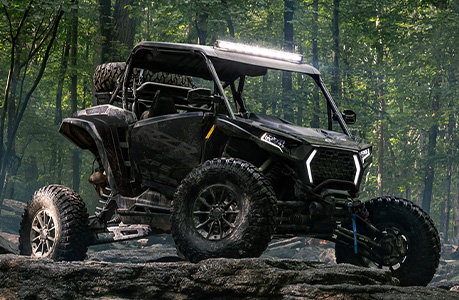 A Polaris RZR XP side-by-side with lighting accessories installed.