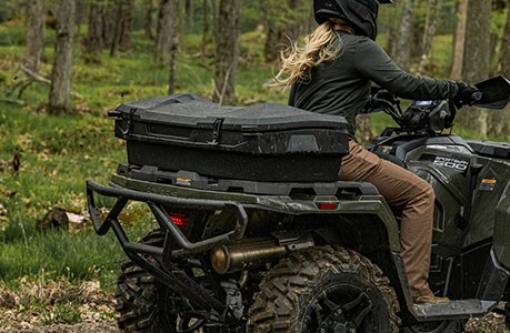 A Polaris Sportsman 500 ATV with a rear cargo box accessory installed.
