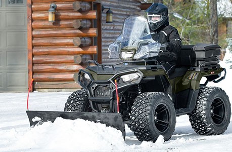 Polaris Sportsman 600 ATV with plow system accessory installed.