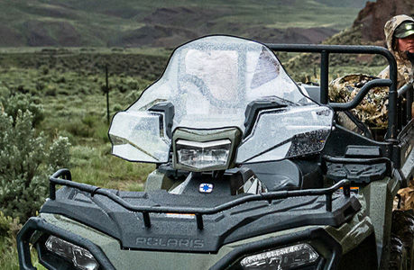 A  Polaris Sportsman 6x6 600 ATV with windshield accessory installed.