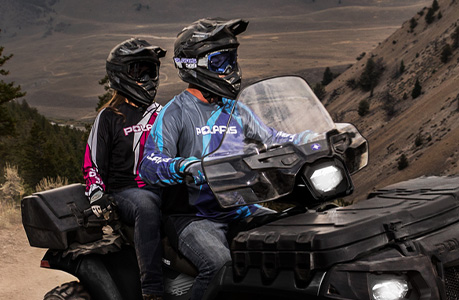 A Polaris Sportsman 850 ATV with windshield accessory installed.