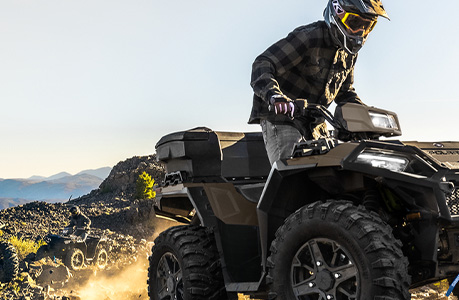 A Polaris Sportsman 850 ATV with rear cargo box accessory installed.