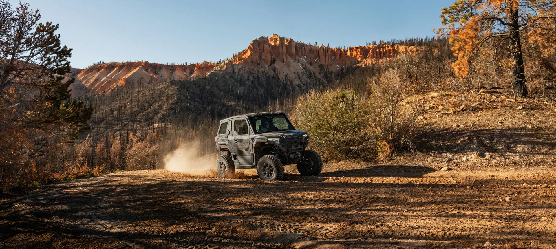 A Matte Super Graphite Polaris XPEDITION ADV NorthStar cruising down a dusty trail.