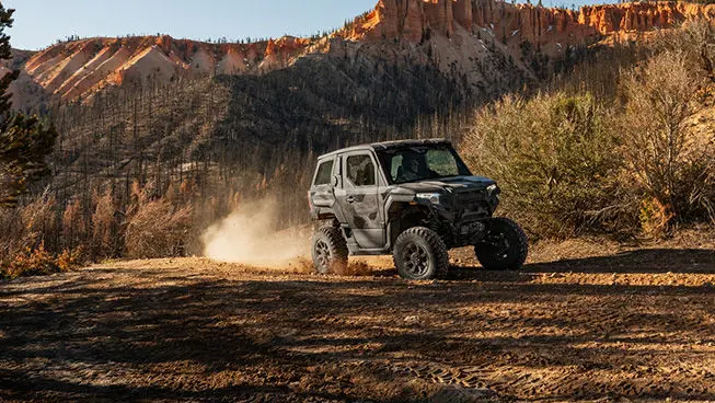A Matte Super Graphite Polaris XPEDITION ADV NorthStar cruising down a dusty trail.