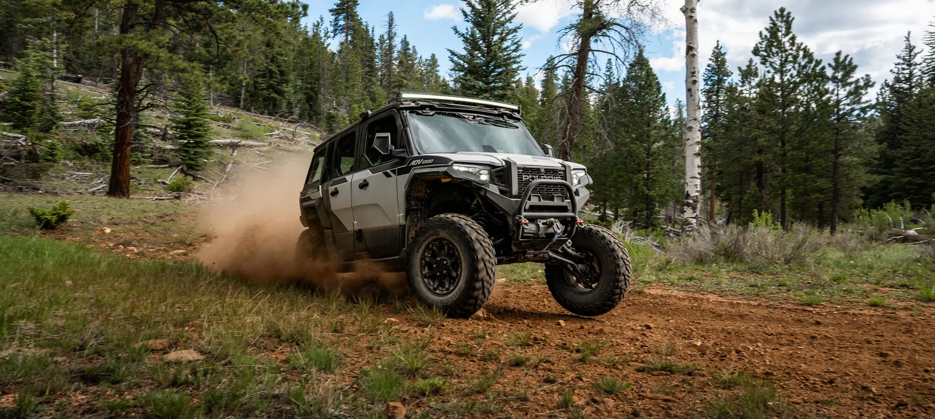 A  Polaris XPEDITION ADV 5 NorthStar driving down a trail.