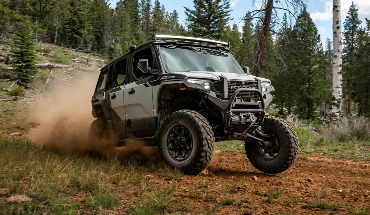 A  Polaris XPEDITION ADV 5 NorthStar driving down a trail.