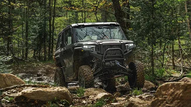 A Matte Super Graphite Polaris XPEDITION ADV NorthStar parked on a hill.