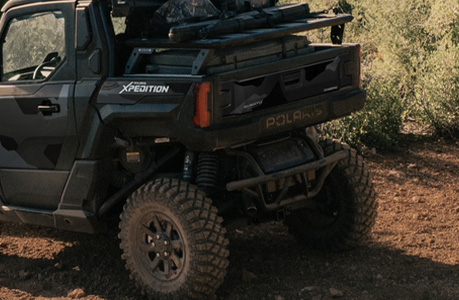 A Polaris XPEDITION performance side-by-side with bumper & guards accessories installed. 