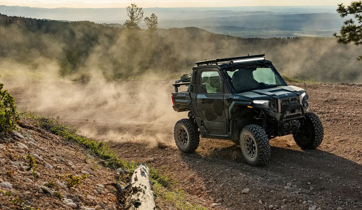 A Polaris XPEDITION XP side-by-side cruising on a trail.