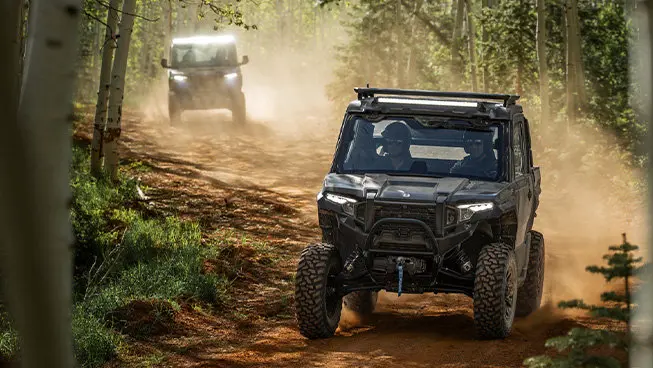 Two Polaris XPEDITION XP NorthStar side-by-sides cruising on a trail.