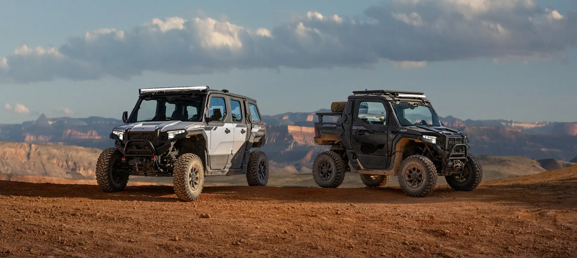 2 Polaris XPEDITION XP NorthStar side-by-sides park on a ridge.