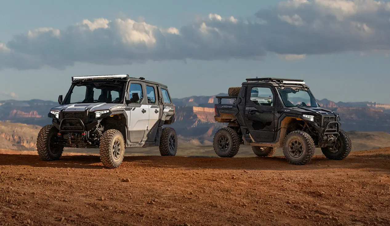 2 Polaris XPEDITION XP NorthStar side-by-sides park on a ridge.