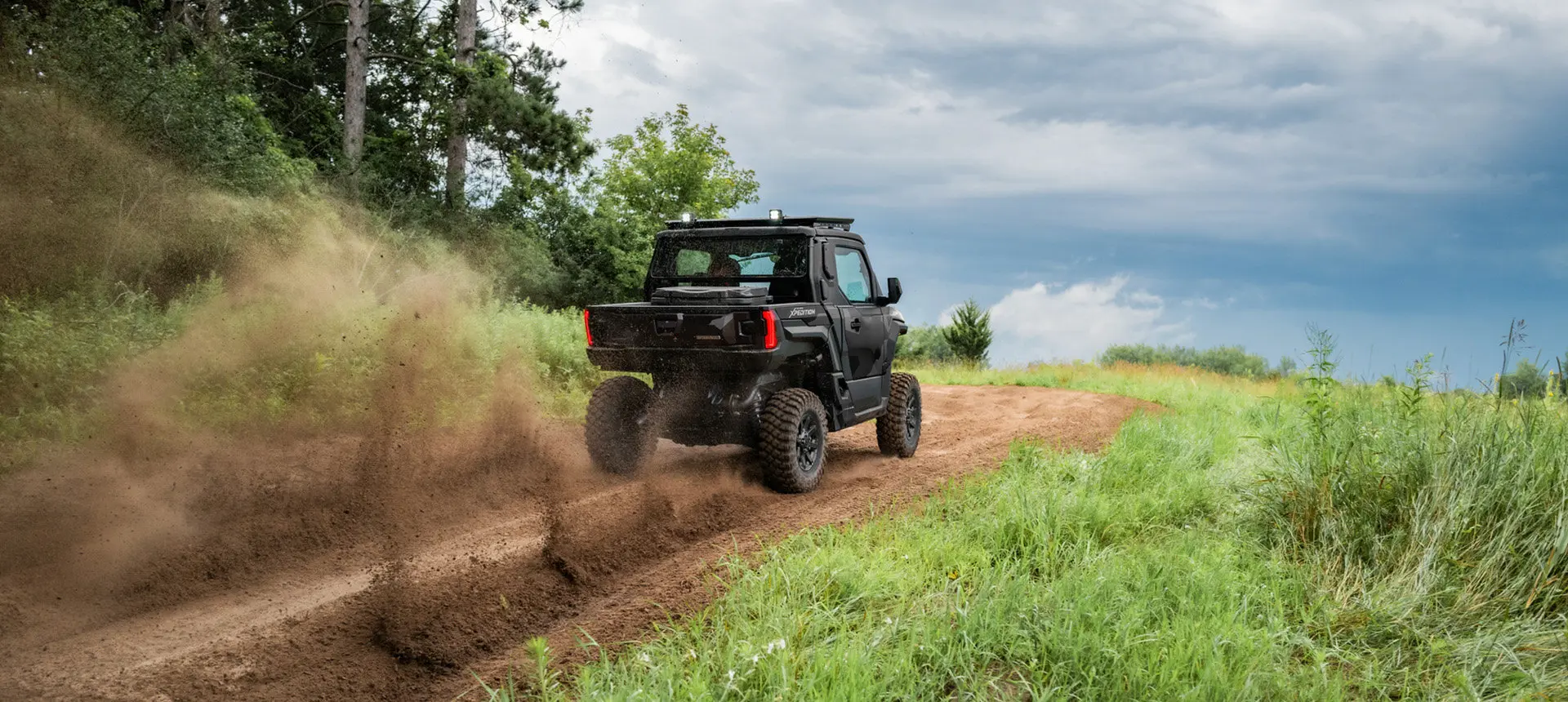 Rear view of a Polaris XPEDITION XP NorthStar side-by-side trail riding.