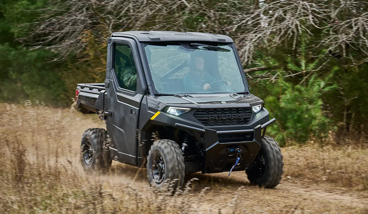 2 riders in a Polaris RANGER 1000 CAB UTV.