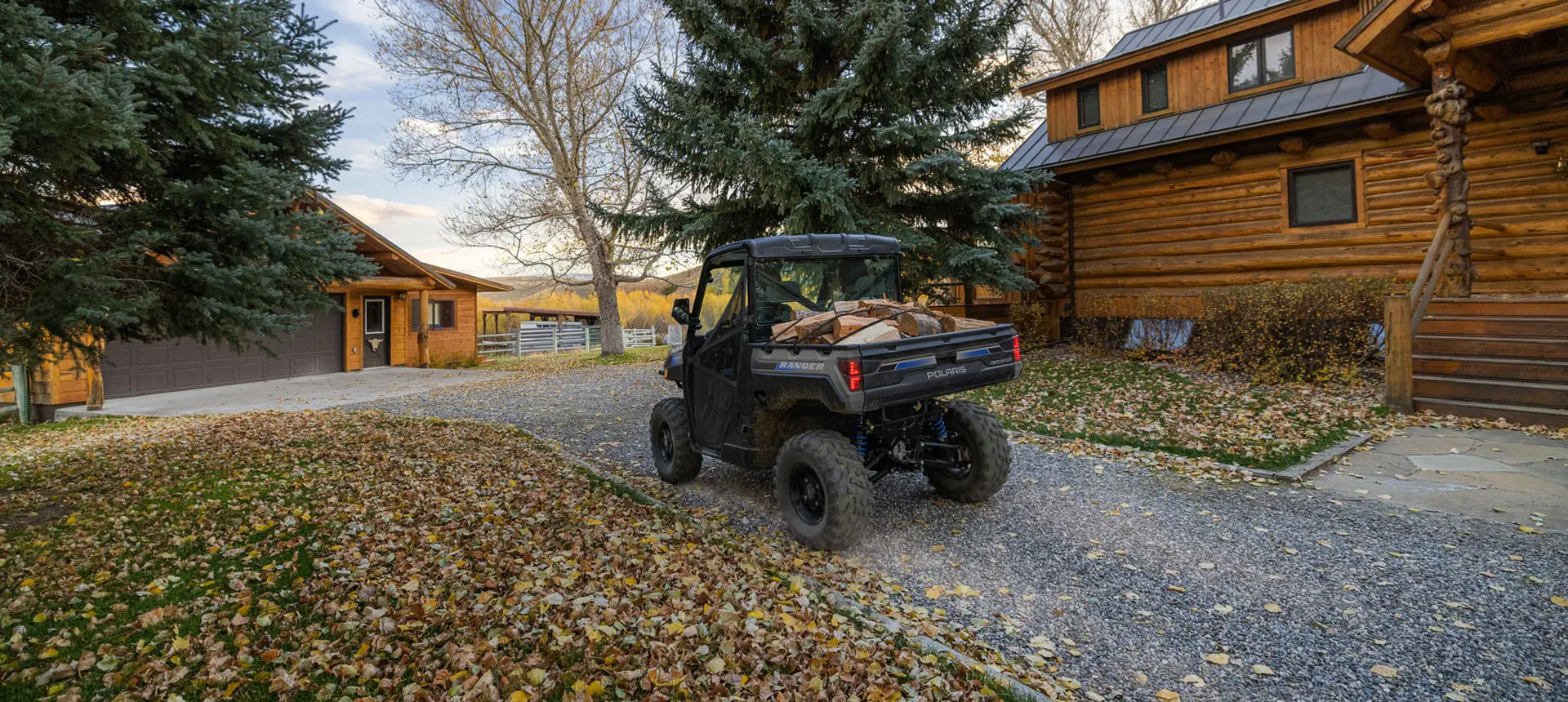 A Polaris RANGER XP Kinetic electric UTV with a cargo box loaded with firewood.
